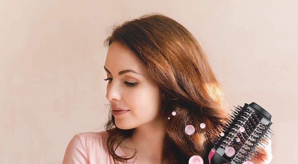 Woman styling soft, glossy waves with the hot air brush